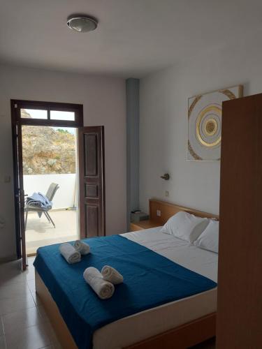 a bedroom with a bed with two towels on it at PHILIPPOS STUDIOS & APT in Lindos