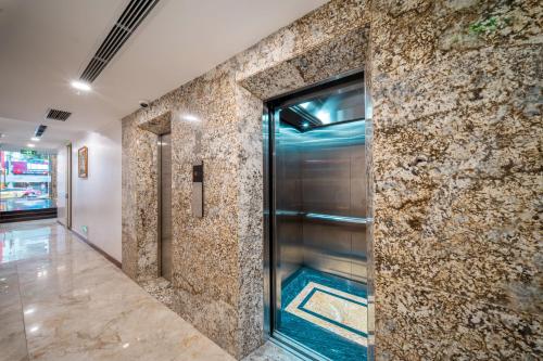 a elevator lobby with a stone wall at WYNNE Hotel Nha Trang in Nha Trang