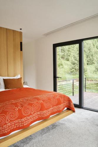 a bedroom with a bed and a large window at Pana Unique Kolsay in Kurmenty