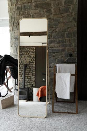a mirror sitting on the floor in a room at Pana Unique Kolsay in Kurmenty