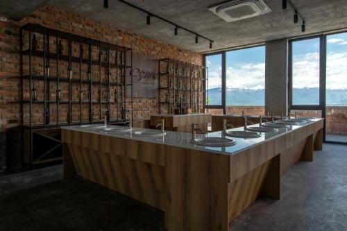 a row of sinks in a large room with windows at The Wine Station in Tsinandali