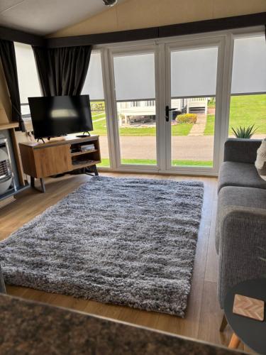 a living room with a couch and a large window at Number 51 in Arbroath