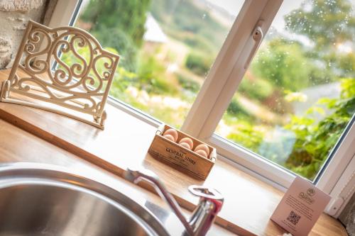 a kitchen sink in front of a window at Dunkery Cottage Wheddon Cross in Wheddon Cross