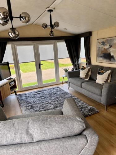 a living room with two couches and a television at Number 51 in Arbroath