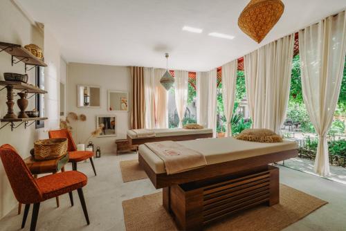 a bedroom with a bed and a desk and chairs at Lill Maison Hotel & City Club in Fethiye