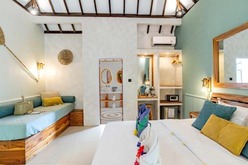 a living room with two beds and a mirror at Bale Sampan Boutique Bungalows in Gili Trawangan