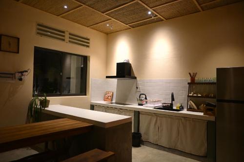 a kitchen with a sink and a counter top at Mer Home in Tây Ninh