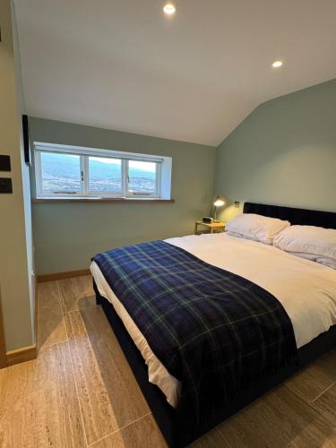 a bedroom with a large bed and a window at The Sheep Barn in Weathercote