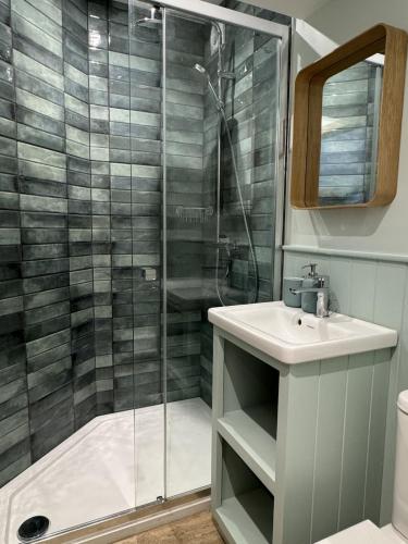 a bathroom with a shower and a sink at The Sheep Barn in Weathercote