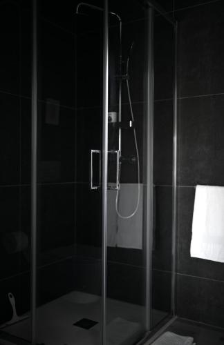 a shower with a glass door in a bathroom at M Butterfly in Alvorge