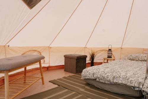 a bedroom with a bed in a tent at Mardi talu Glamping in Paekna