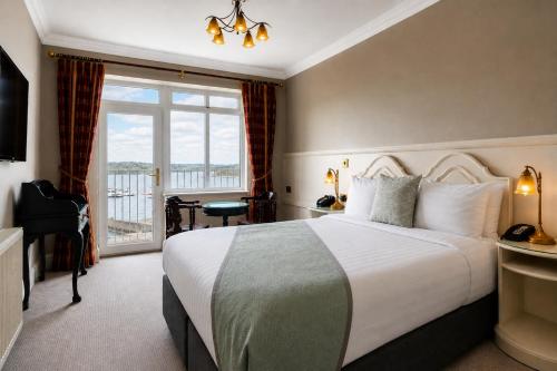 a bedroom with a large bed and a balcony at Lakeside Manor Hotel in Virginia