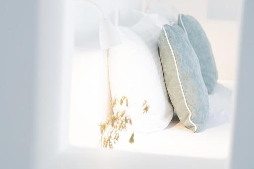a shelf with a white bottle and some towels at Harmony Hotel in Sarandë