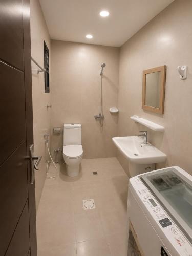 a bathroom with a toilet and a sink at RED Gardenia in Salalah