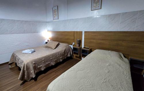 a hotel room with two beds in a room at Hotel Internacional in Tacuarembó
