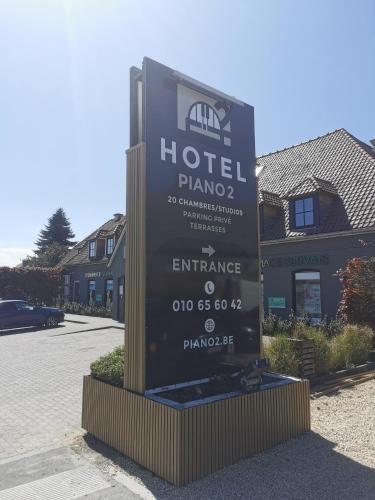 a sign for a hotel in front of a building at Hotel B&R Piano 2 - Louvain-la-Neuve - Mont Saint Guibert in Louvain-la-Neuve