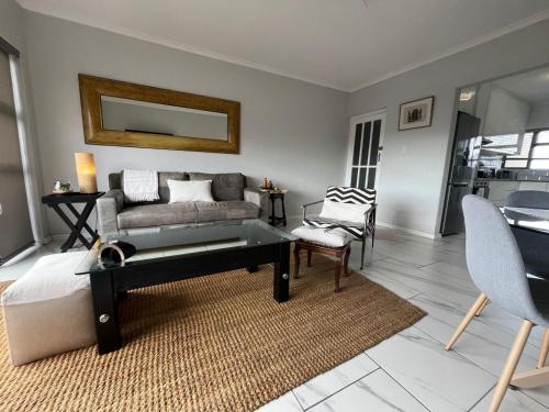 a living room with a couch and a table at T&A Escape in Grassy Park