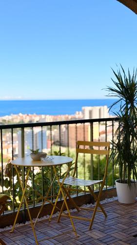 a patio with a table and chairs on a balcony at Riviera Heights Monaco in Beausoleil