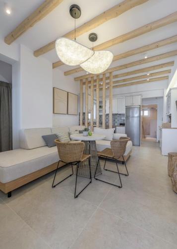 a living room with a couch and a table at Michalakis Seaside Suites in Pollonia