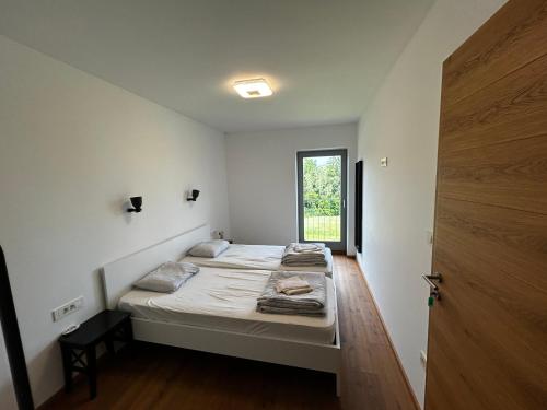 a small bedroom with a bed and a window at Barn House in Ptuj