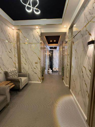 a hallway in a hotel with a room with marble walls at Nigrum Hotel Nevsehir Cappadocia in Nevşehir
