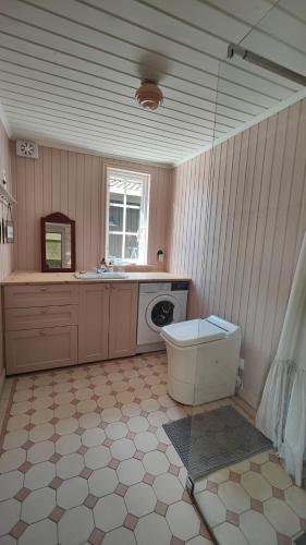 a bathroom with a sink and a washing machine at Haus Hav in Ronneby