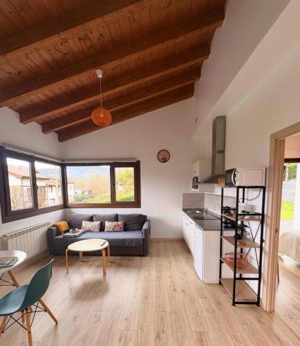 a living room with a couch and a table at Apartamentos El Respigu in Cangas de Onís