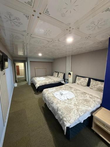 a room with two beds and a ceiling at Nigrum Hotel Nevsehir Cappadocia in Nevşehir