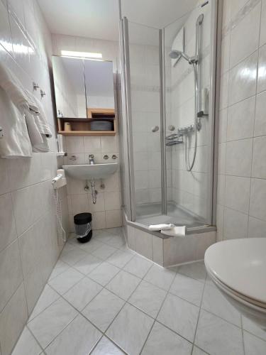 a bathroom with a shower and a sink at Pension Speckmoser in Bad Mitterndorf