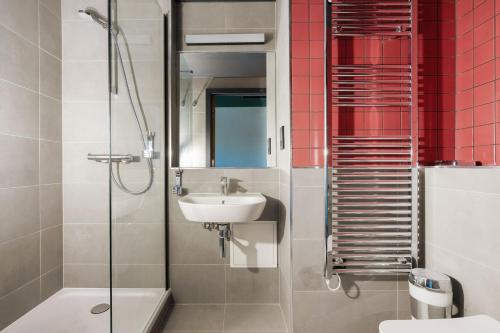 a bathroom with a sink and a toilet and a shower at MEININGER Hotel Edinburgh Haymarket in Edinburgh
