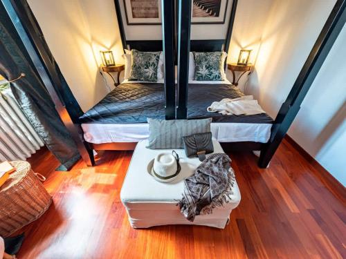 two twin beds in a room with wooden floors at Apartment Panzano in Panzano