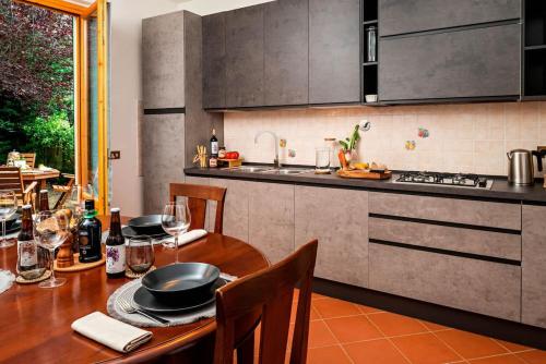 a kitchen with a wooden table with chairs and a sink at Apartment Panzano in Panzano