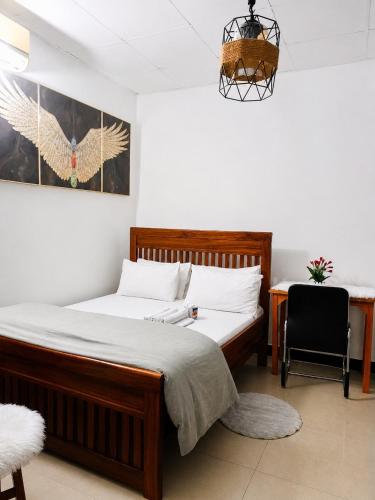 a bedroom with a bed and a desk and a chair at 1BDM Aptmt Free Wifi,TV, NETFLIX,FRIDGE,KITCHEN-busy area in Dar es Salaam