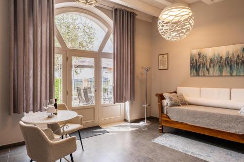 a living room with a bed and a large window at Corte Lavarini in Fumane