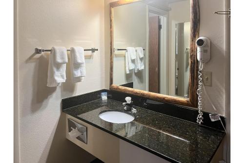 a bathroom with a sink and a mirror at Studio 6 Suites Butte MT I-90 I-15 in Butte