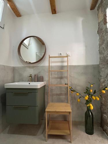 a bathroom with a sink and a mirror at Stone house Vert in Sveti Jakov