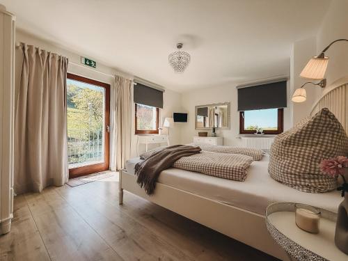 a bedroom with a large bed and a window at Feriendorf Falkenegg in Lennestadt