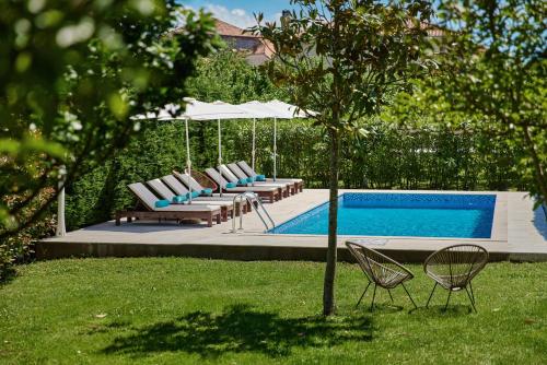 a group of chairs and a swimming pool at Villa MontAnja in Herceg-Novi