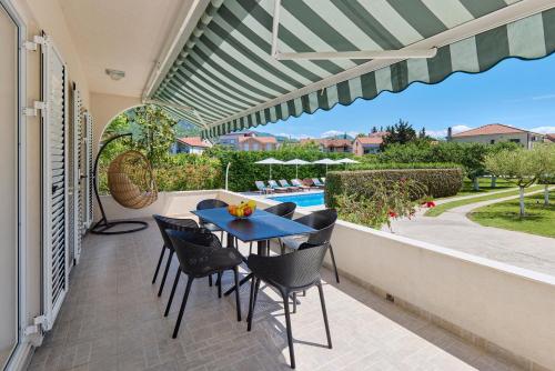 a patio with a table and chairs and a pool at Villa MontAnja in Herceg-Novi
