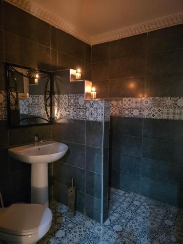 a bathroom with a sink and a toilet at Riad Anbar in Marrakesh