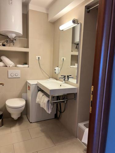 a bathroom with a sink and a toilet at Pine Resort by Residence in Strožanac
