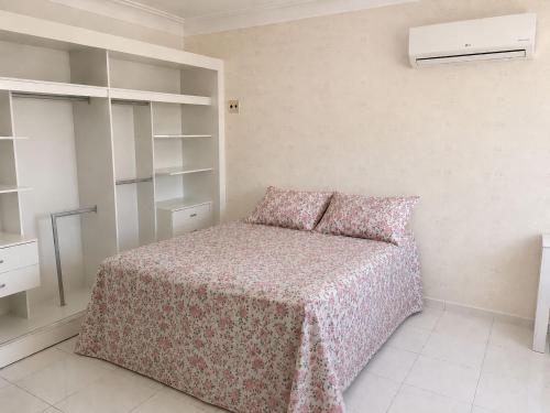 a small bedroom with a bed and a closet at Casa in Petrolina