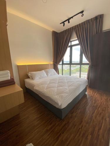 a bedroom with a bed and a large window at K Avenue by FRHome, 2 bedroom apartment within 5 min to KKIA airport in Kota Kinabalu