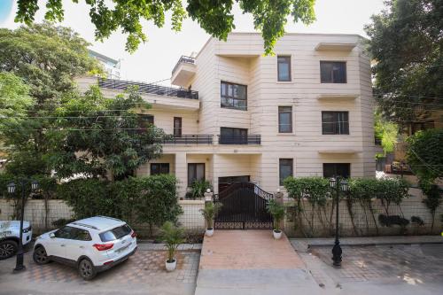 a white car parked in front of a building at Studio Serviced Apartments near Fortis Hospital in Gurgaon