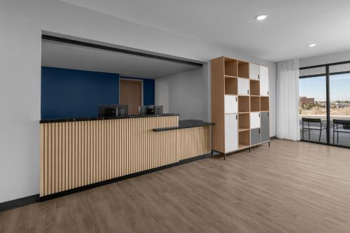 an office with a reception desk and a large room at StudioRes by Marriott Denver Tech Center in Centennial