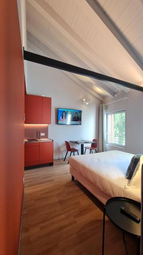 a bedroom with a large bed and a table at Michelangelo House, your personal Studio in Mestre