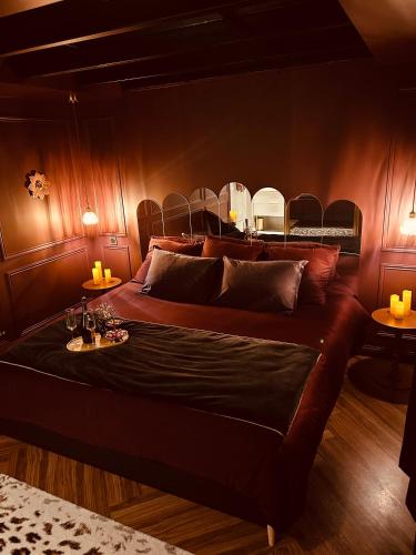 a bedroom with a large bed with wooden walls at Clos des Voluptés in Fargues-Saint-Hilaire
