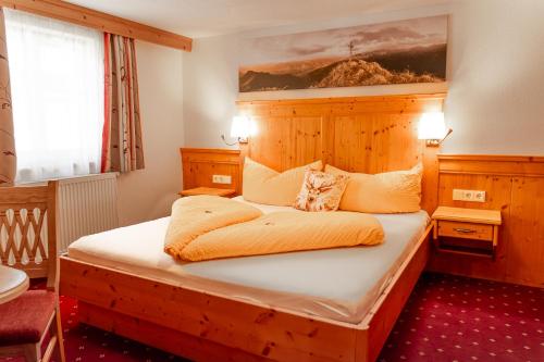 a bedroom with a large bed in a room at Franzerhof in Mittersill