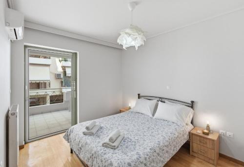 a bedroom with a bed with two towels on it at Moschato-Niarchos modern apartment in Piraeus