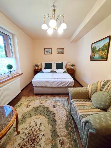 a bedroom with a bed and a couch at Leśny Poranek in Iwkowa